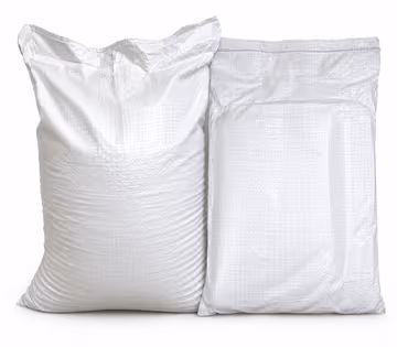 Two filled white HDPE woven sacks standing side by side