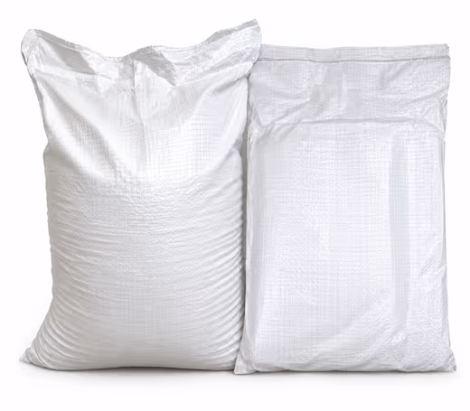 Two filled white HDPE woven sacks standing side by side