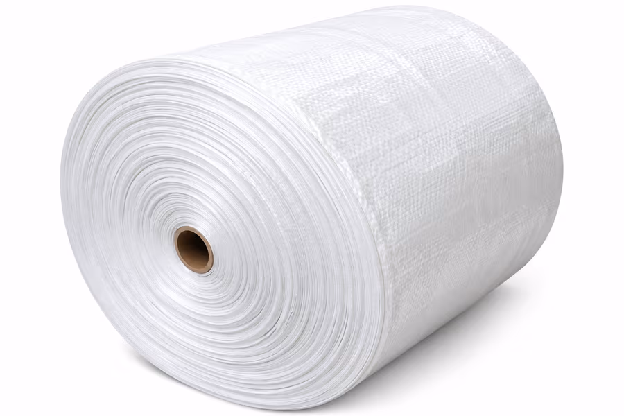 A large roll of white PP woven fabric, seen from the side
